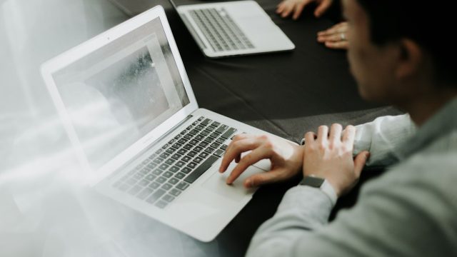 Laptop workspace illustration for OneDrive synchronization troubleshooting