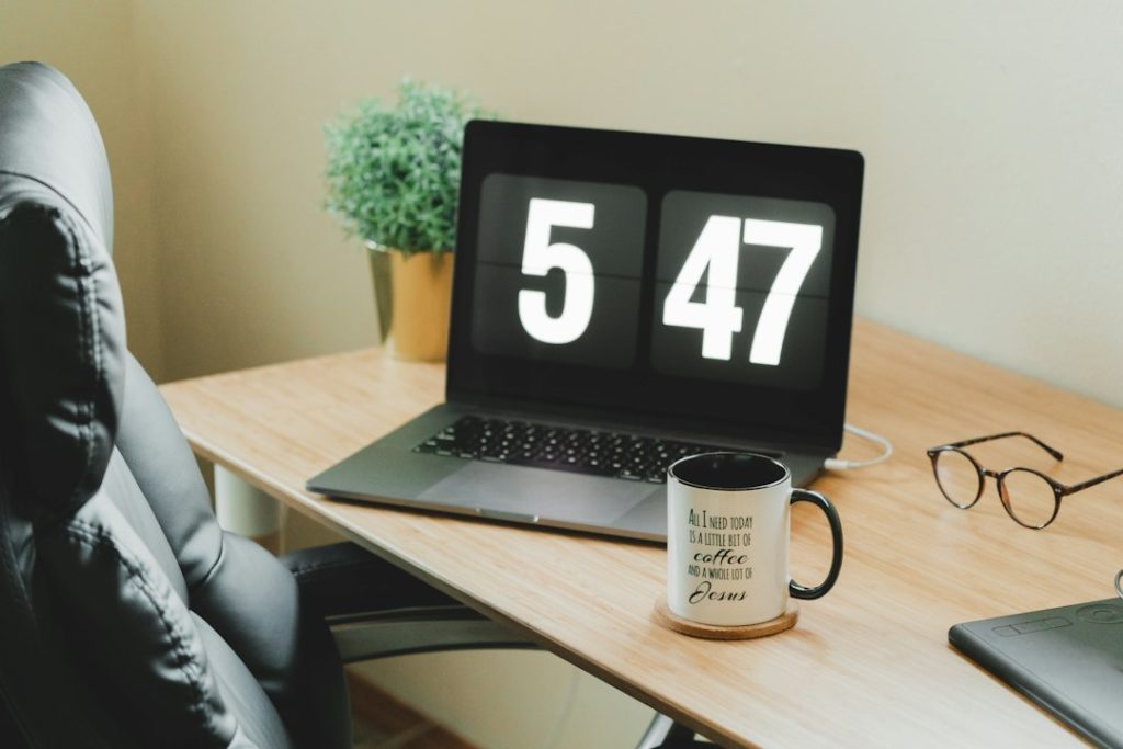 Laptop and work essentials illustrating planning and scheduling an email